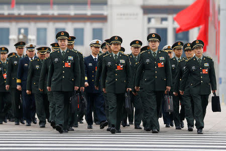 Military delegates arrive for the fifth plenary session of the National People's Congress (NPC) at the Great Hall of the People in Beijing, China March 17, 2018. REUTERS/Thomas Peter