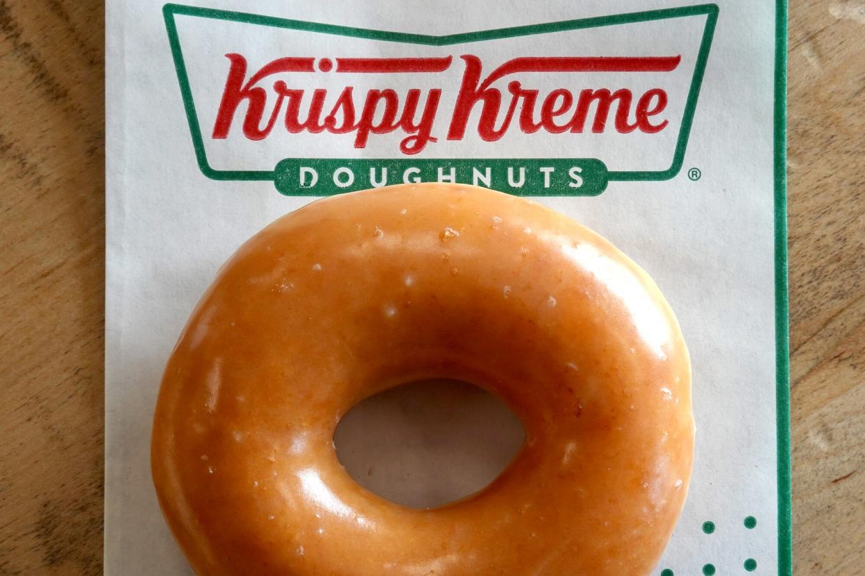 In this photo illustration, a Krispy Kreme glazed doughnut is shown on May 12, 2022 in Daly City, California. Krispy Kreme reported strong first quarter earnings with net income of $4 million compared with a loss of $3.06 million one year ago.