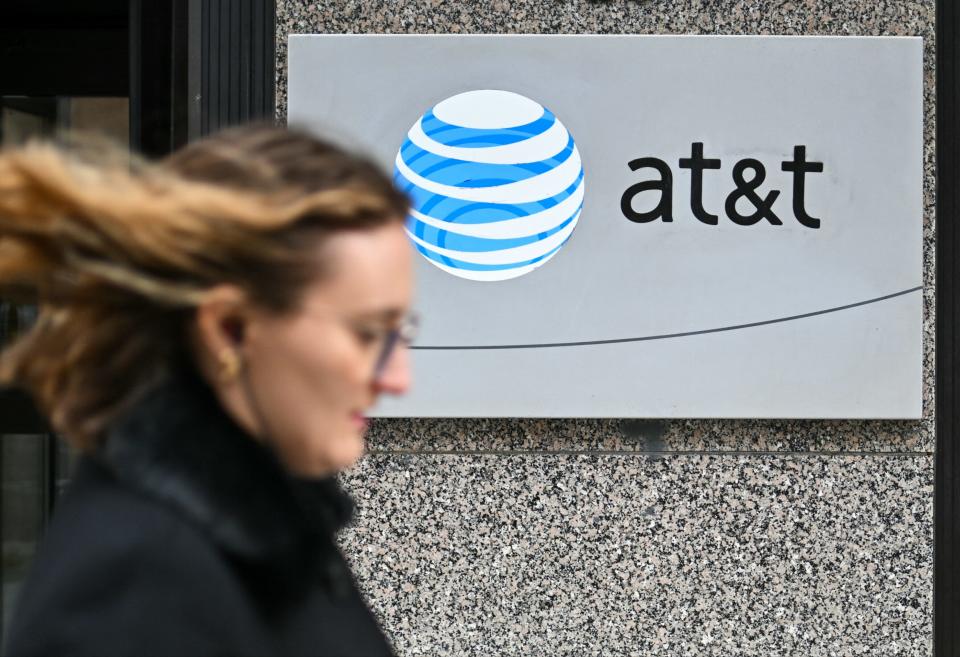 Woman walking by AT&T sign in February 2024.