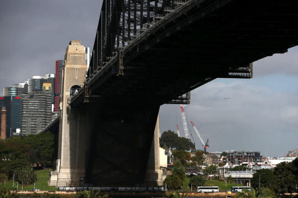 Sydney Harbor Bridge stands next to commercial and residential buildings in the central business district in Sydney, Australia. Source: Getty