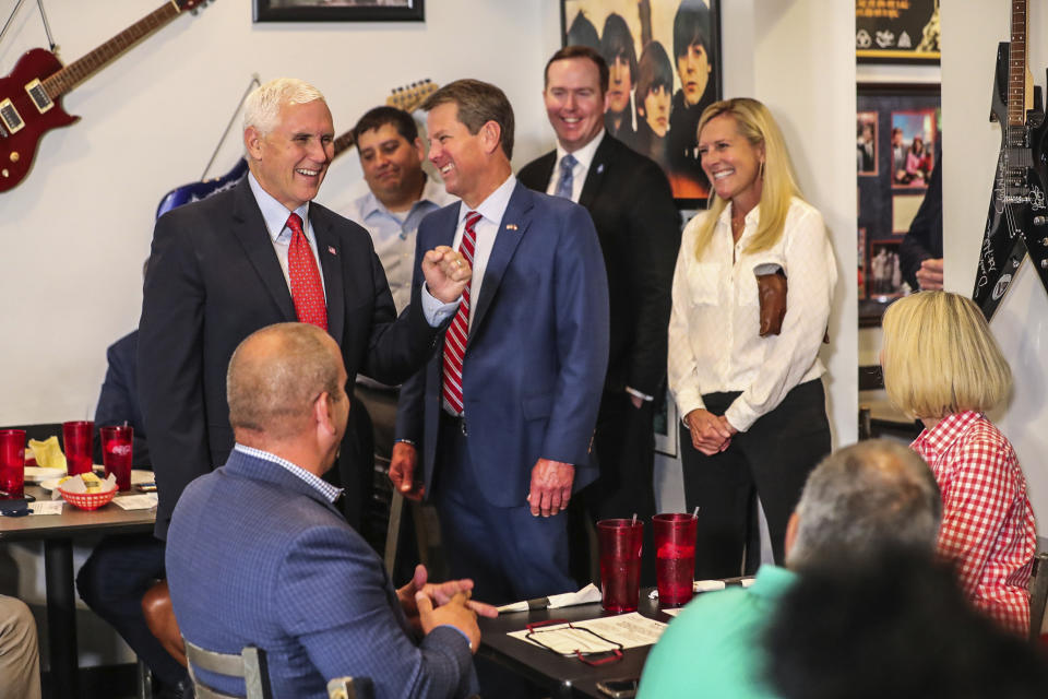 Vice President Mike Pence, left, joins Georgia Gov. Brian Kemp, center, and his wife Marty Kemp, right, for lunch at the Star Cafe, Friday, May 22, 2020, in Atlanta. Pence said Georgia was "leading the way" and the country was making progress against the coronavirus. (John Spink/Atlanta Journal-Constitution via AP)