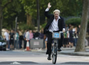 FILE - In this Friday, July 30, 2010 file photo Boris Johnson Mayor of London waves to the media as he helps launch a new cycle hire scheme in London. (AP Photo/Alastair Grant, File)
