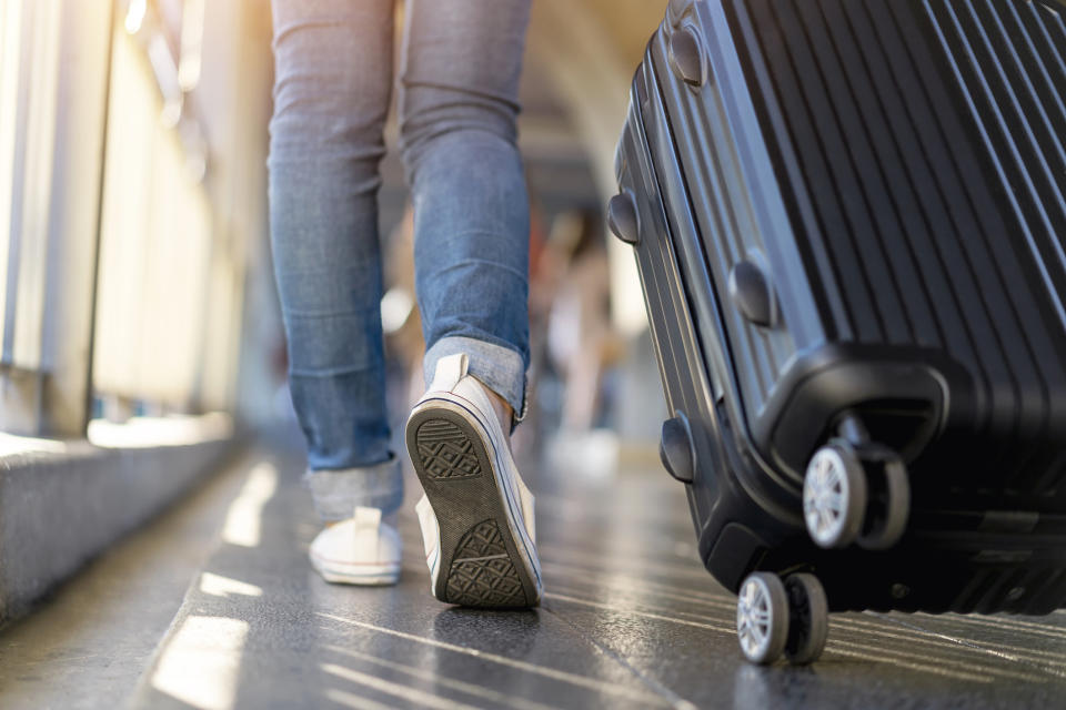 person rolling a luggage bag in the airport