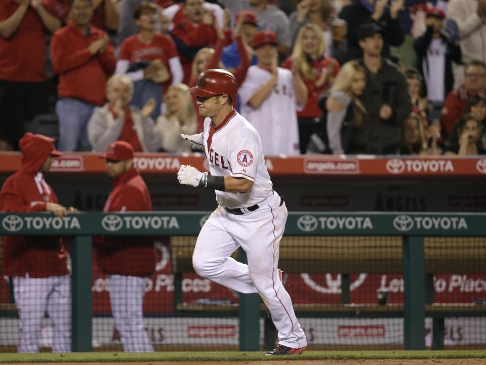 Los Angeles Angels' Kole Calhoun runs toward home plate after hitting a two-run home run during the fourth inning of a baseball game against the Oakland Athletics on Tuesday, April 15, 2014, in Anaheim, Calif. (AP Photo/Jae C. Hong)