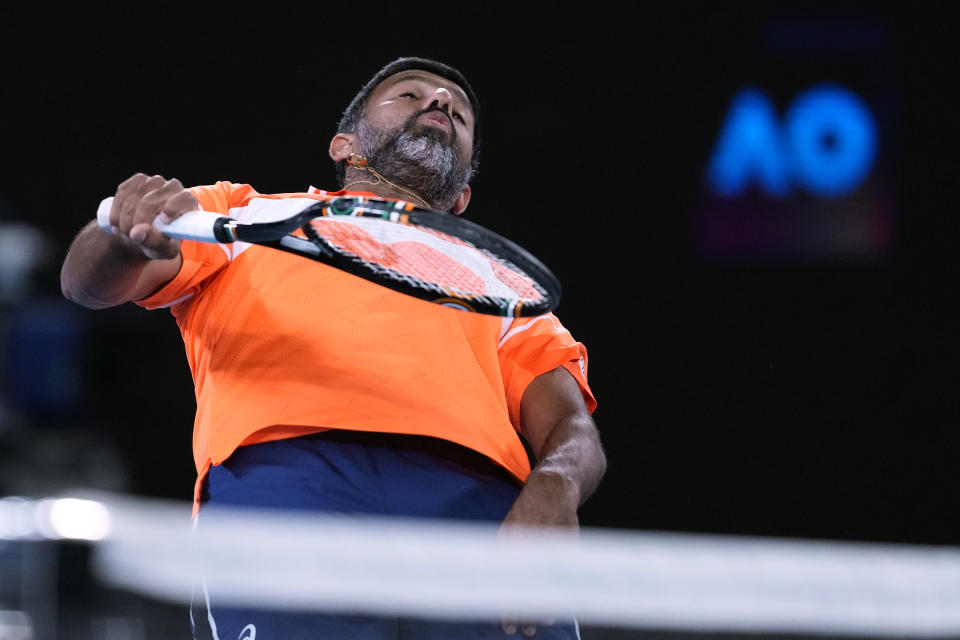 Rohan Bopanna of India and his partner Matthew Ebden, not in photo, of Australia play Simone Bolelli and Andrea Vavassori of Italy during the men's doubles final the Australian Open tennis championships at Melbourne Park, Melbourne, Australia, Saturday, Jan. 27, 2024. (AP Photo/Alessandra Tarantino)