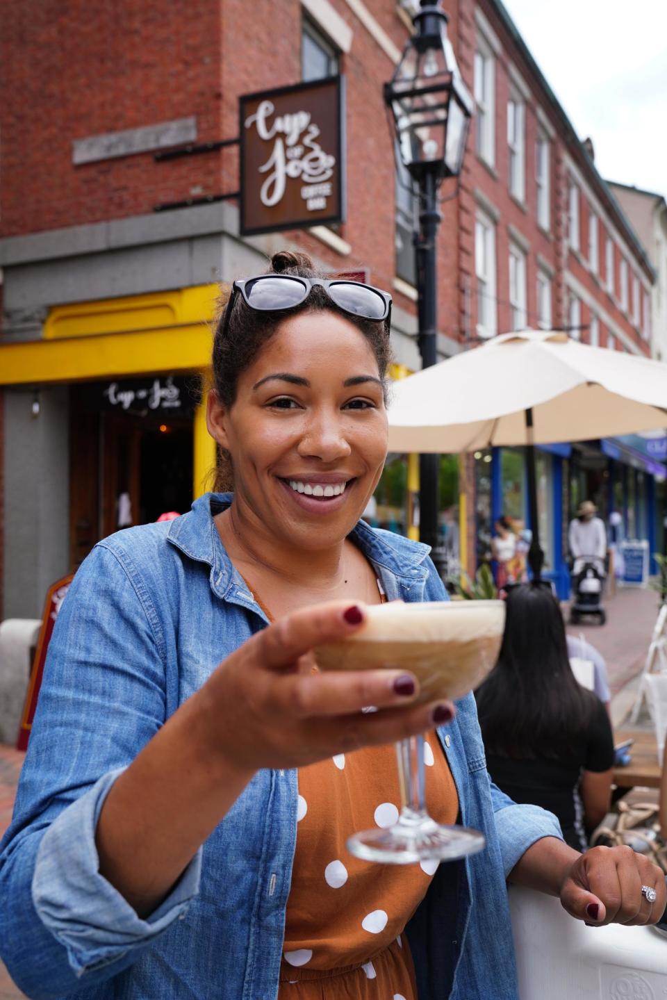 The owner of a coffee bar that sells alcohol in Portsmouth, New Hampshire, holds an adult beverage outdoors. Here in North Carolina, Fayetteville may soon allow people to drink alcoholic beverages on public streets and sidewalks in its downtown area.