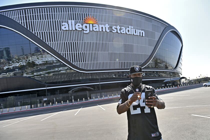 A Las Vegas Raiders fan takes a selfie outside Allegiant Stadium