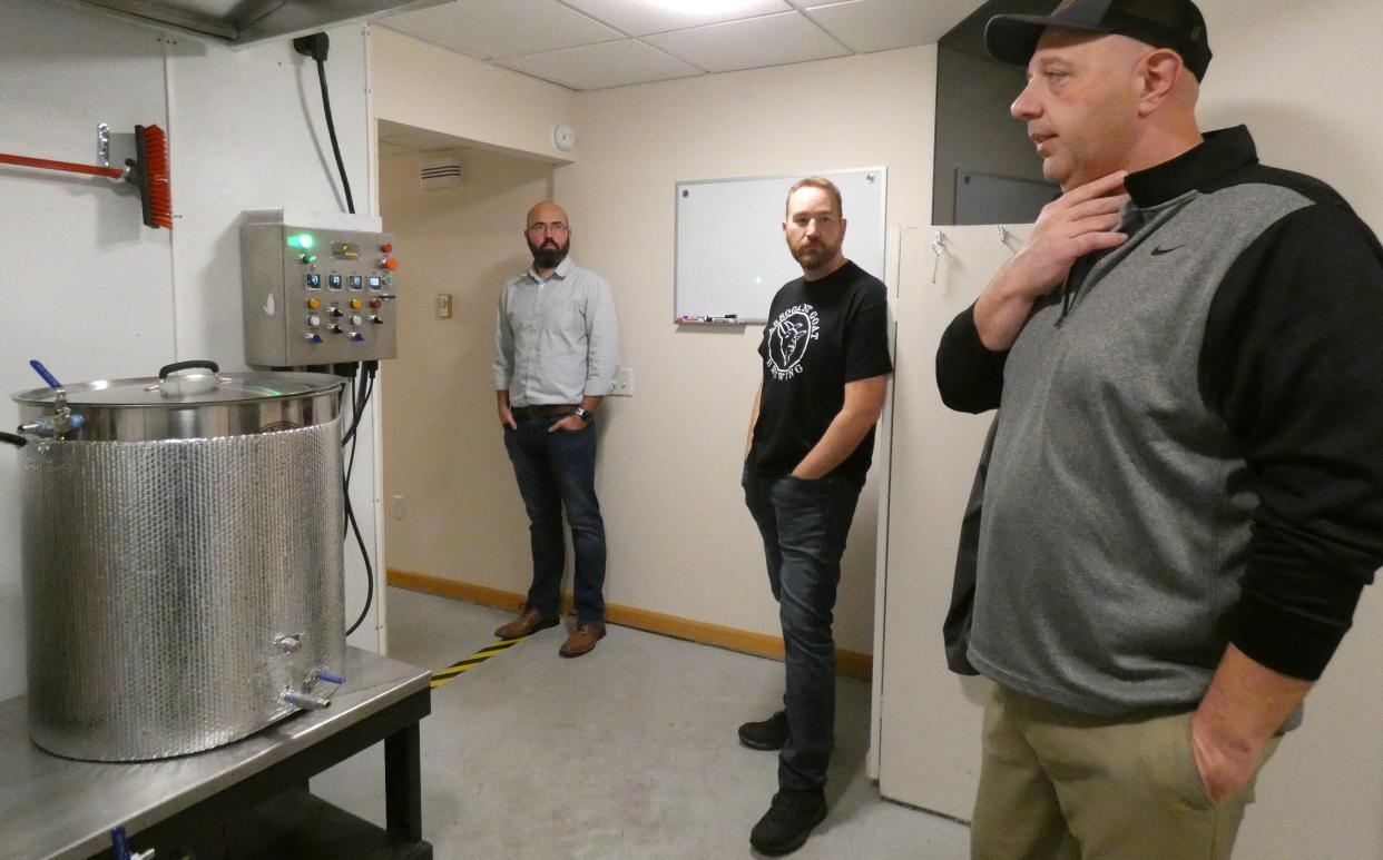 Co-owners David Jones, Zach Osborn and Mark Burke, from left, stand in the brewing room at Arrogant Goat Brewing, 125A E. Rensselaer St.