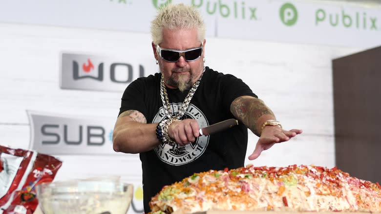 Guy Fieri cutting a super large burrito