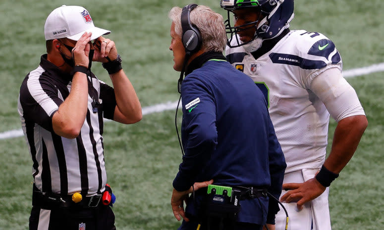 Pete Carroll speaks with an official.