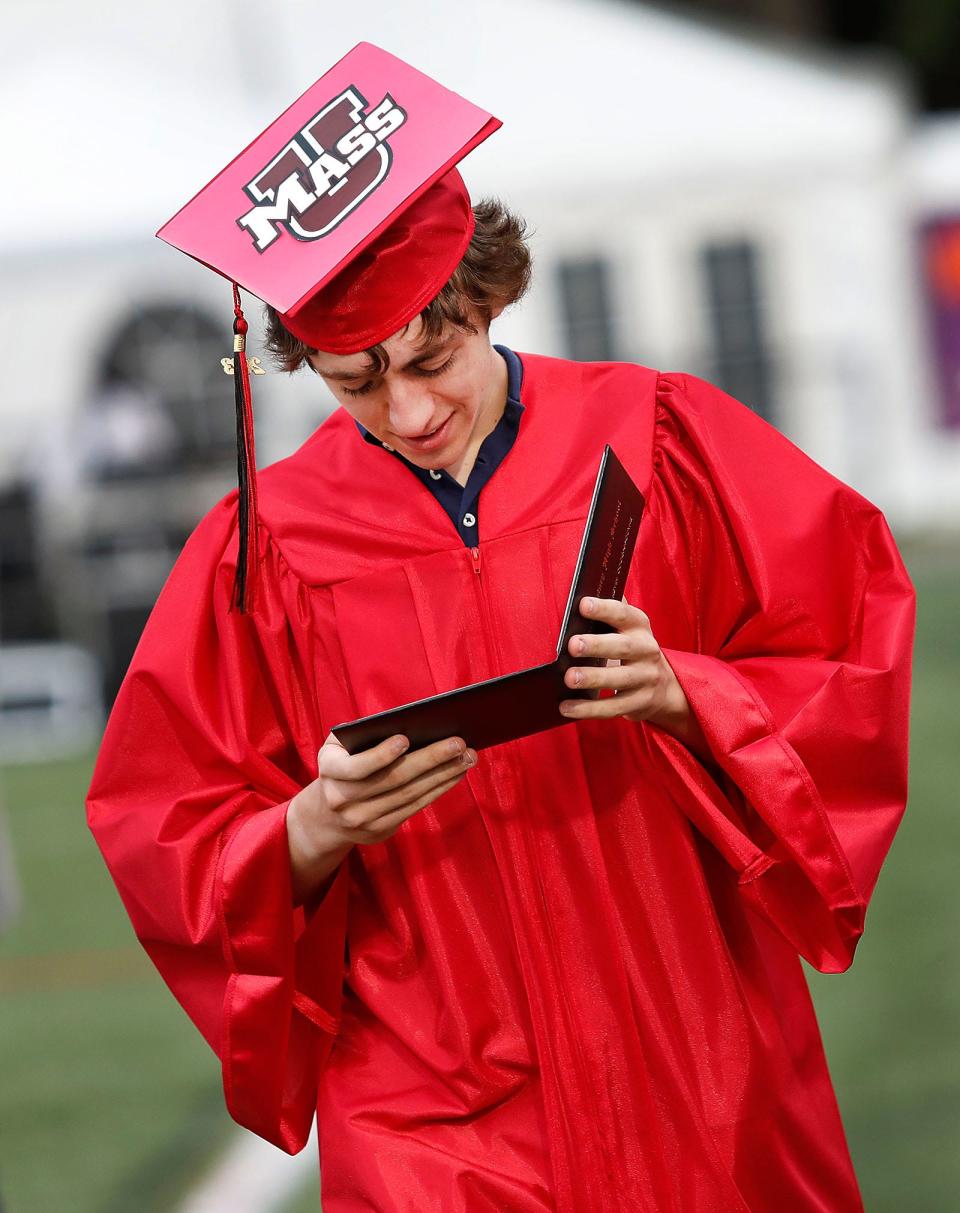 Oisin Dermot Coogan-Coyne checks his diploma. North Quincy High graduation exercises at Veterans Stadium on Tuesday June 6, 2023