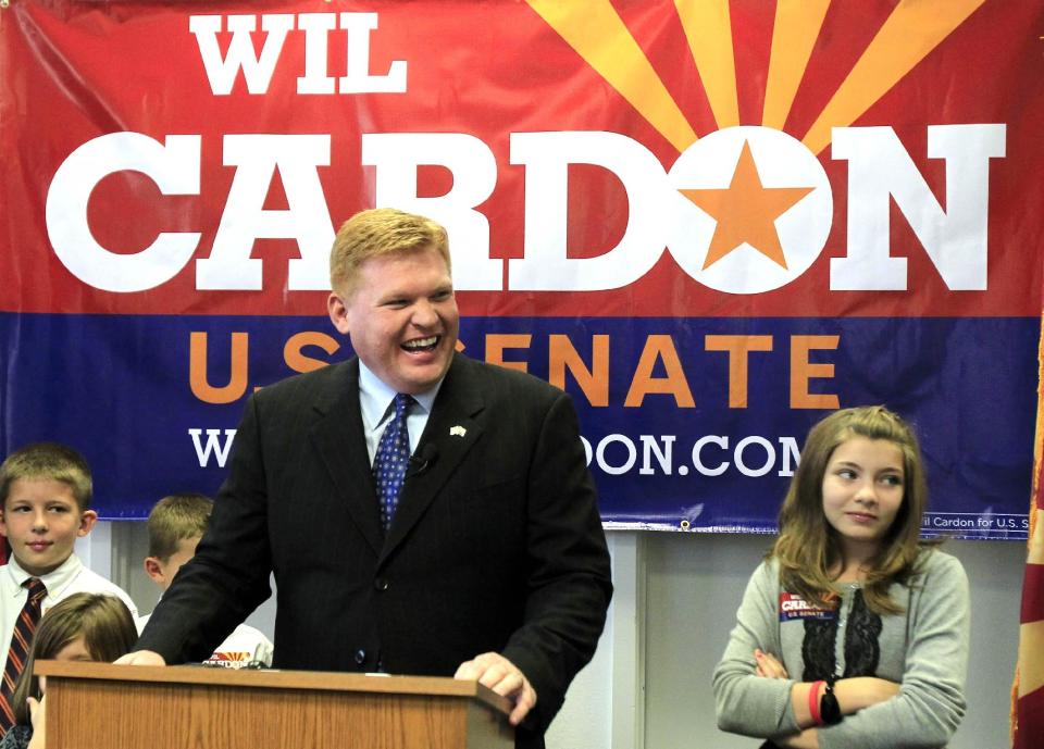 FILE - In this Nov. 15, 2011 file photo, Mesa, Ariz. businessman Wil Cardon, center, flanked by two of his five children, Rebecca Cardon, 11, right, and Parley Cardon, 10, begins his U.S. Senate statewide campaign in Phoenix. Seemingly out of nowhere, a trio of wealthy political neophytes has roiled Republican Senate primary races taking place this month, dipping into their personal fortunes to highlight their business backgrounds, cast their opponents as career politicians and draw within striking distance of a victory few saw coming just a few weeks ago. Cardon is still viewed as having work to do if he's going to catch the prohibitive favorite in the race _ six-term Rep. Jeff Flake. (AP Photo/Ross D. Franklin, File)