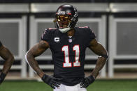 FILE - In this Sunday, Dec. 6, 2020, file photo, Atlanta Falcons wide receiver Julio Jones (11) warms up before an NFL football game against the New Orleans Saints in Atlanta. The Tennessee Titans have traded with the Atlanta Falcons for seven-time Pro Bowl wide receiver Julio Jones, a person familiar with the situation told The Associated Press. (AP Photo/Danny Karnik, File)