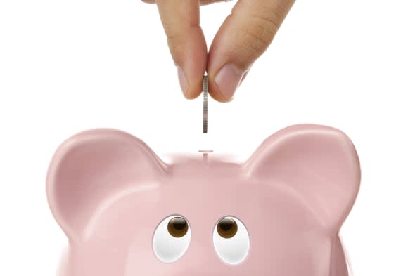 Piggy bank looking up for the coin isolated on white