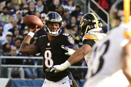 Nov 4, 2018; Baltimore, MD, USA; Baltimore Ravens quarterback Lamar Jackson (8) throws as Pittsburgh Steelers defensive end Cameron Heyward (97) applies pressure during the third quarter at M&T Bank Stadium. Mandatory Credit: Tommy Gilligan-USA TODAY Sports