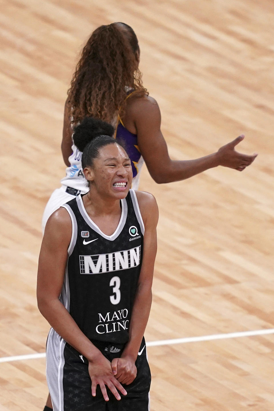 Minnesota Lynx forward Aerial Powers (3) winces as she grabs her thumb after taking a hit during the second quarter against the Los Angeles Sparks in a WNBA basketball game Saturday, June 12, 2021, in Minneapolis. (/Star Tribune via AP)