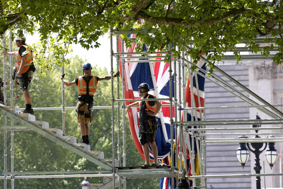 Building work in preparation for the Platinum Jubilee celebrations take place in front of Buckingham Palace in London, Friday, May 6, 2022. Britain's Queen Elizabeth II acceded to the throne on the death of her father King George VI on Feb. 6, 1952, and the Platinum Jubilee bank holiday weekend celebrations will take place on June 2-5.(AP Photo/Kirsty Wigglesworth)