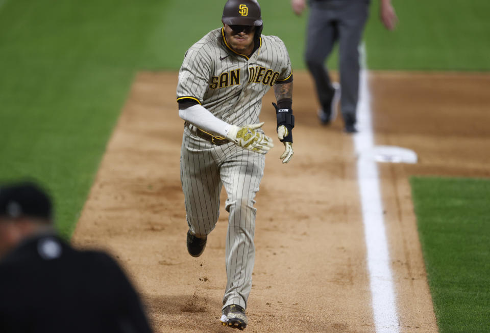 San Diego Padres' Manny Machado advances from third base to score on a passed ball against the Colorado Rockies in the sixth inning of a baseball game Friday, July 31, 2020, in Denver. (AP Photo/David Zalubowski)