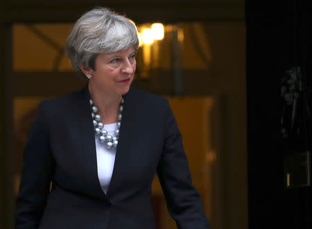 Britain's Prime Minister Theresa May walks out of 10 Dowining Street to welcome Ireland's Taoiseach Leo Varadkar in London, September 25, 2017. REUTERS/Hannah McKay