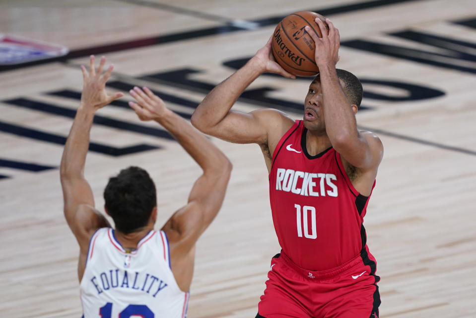 Houston Rockets' Eric Gordon (10) shoots over Philadelphia 76ers' Raul Neto (19) during the first half of an NBA basketball game Friday, Aug. 14, 2020, in Lake Buena Vista, Fla. (AP Photo/Ashley Landis, Pool)