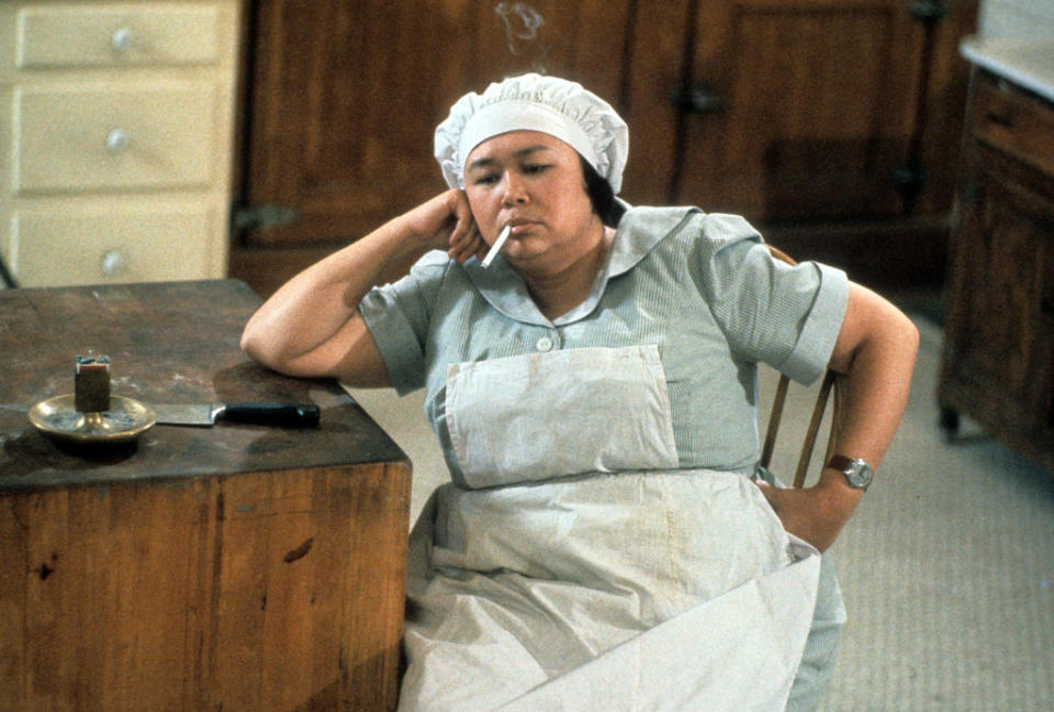 Kellye Nakahara dressed in a maids uniform while smoking a cigarette in a scene from the film 'Clue', 1985<span class="copyright">Courtesy of Paramount Pictures/Getty Images</span>