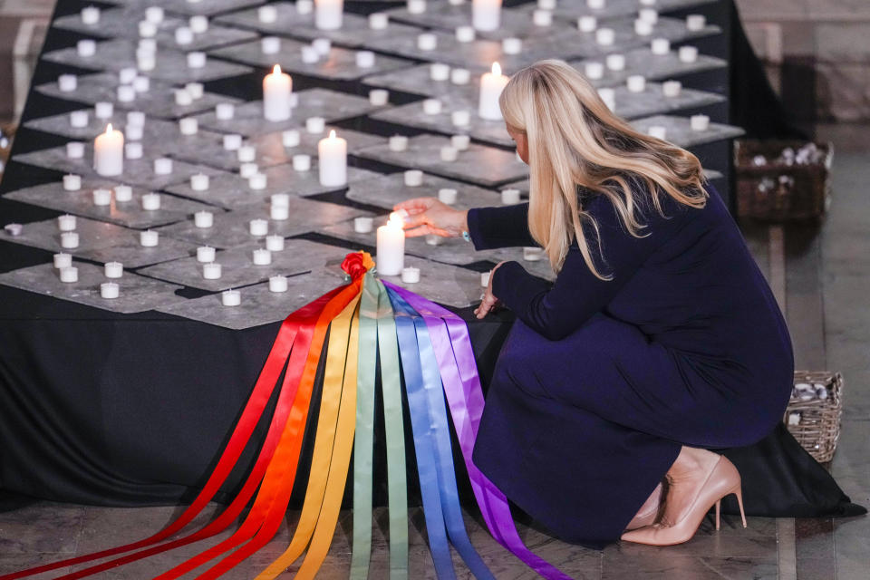 Norway's Crown Princess Mette-Marit lights candles during a service in Oslo Cathedral, Oslo, Sunday June 26, 2022, after an attack in Oslo on Saturday. A gunman opened fire in Oslo’s nightlife district early Saturday, killing two people and leaving more than 20 wounded in what the Norwegian security service called an "Islamist terror act" during the capital’s annual LGBTQ Pride festival. (Javad Parsa/NTB via AP)