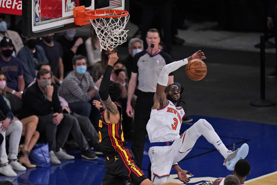 New York Knicks' Nerlens Noel, right, blocks a shot by Atlanta Hawks' John Collins, left, during the first half of Game 1 of an NBA basketball first-round playoff series, Sunday, May 23, 2021, in New York. (AP Photo/Seth Wenig, Pool)