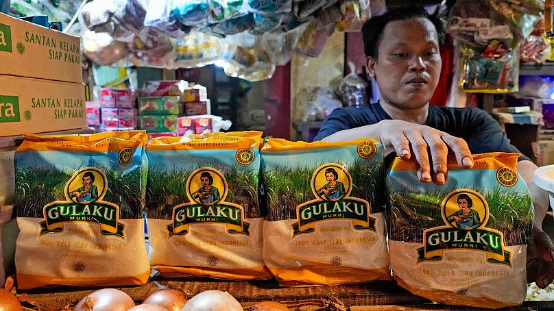 A vendor arranges packages of sugar at a market in Jakarta, Indonesia on 24 October 2023.
