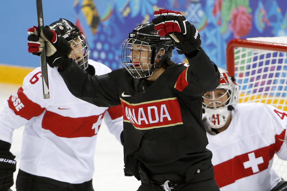 Tara Watchorn of Canada celebrates her goal as Julia Marty of Switzerland, left, and Goalkeeper Florence Schelling look on during the first period of the women's ice hockey game at the Shayba Arena during the 2014 Winter Olympics, Saturday, Feb. 8, 2014, in Sochi, Russia. (AP Photo/Petr David Josek)