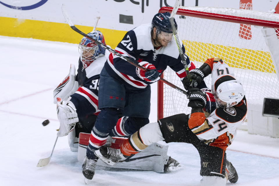 Washington Capitals right wing Nic Dowd (26) defends against Anaheim Ducks center Adam Henrique (14) while Capitals goaltender Darcy Kuemper (35) reaches for the puck during the third period of an NHL hockey game Tuesday, Jan. 16, 2024, in Washington. (AP Photo/Manuel Balce Ceneta)