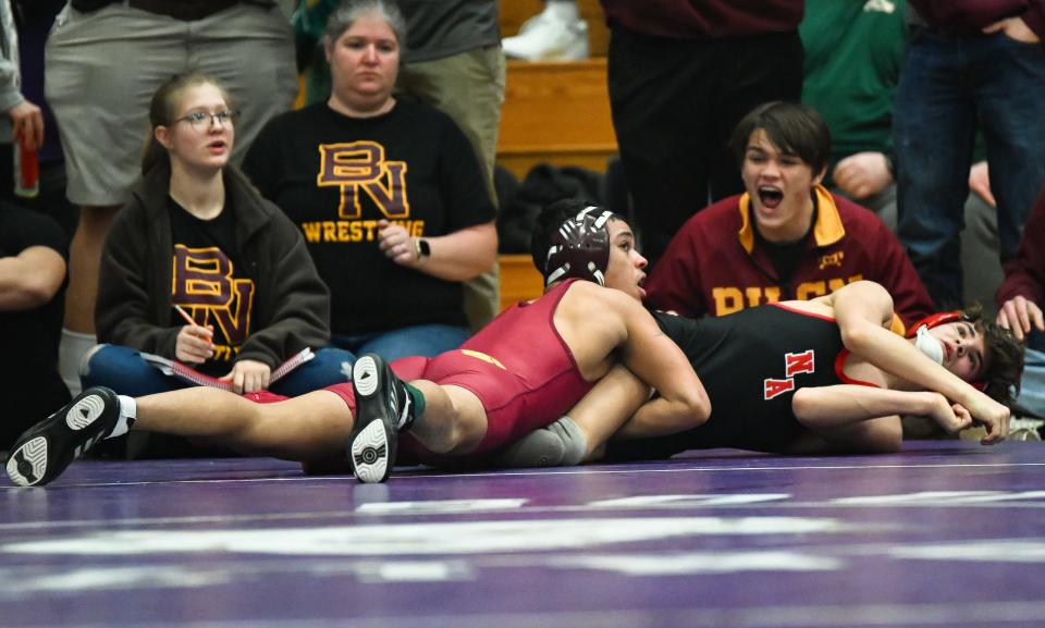 Bloomington North's Trae Hopkins (left) wrestles against New Albany’s Jaden Harris in the 132-pound first round during the IHSAA wrestling regional at Bloomington South on Saturday, Feb. 3, 2024.