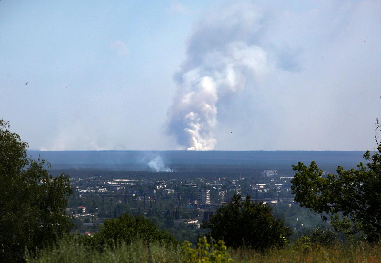 A picture taken on June 21, 2022 from the town of Lysychansk, shows a large plume of smoke rising on the horizon, behind the town of Severodonetsk, amid the Russian invasion of Ukraine. 