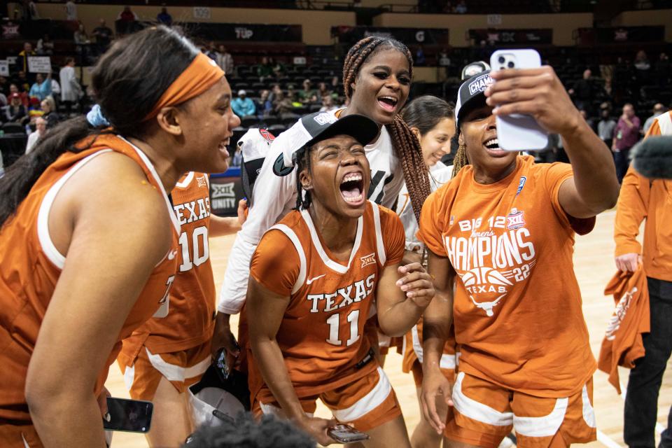 Texas senior guard Joanne Allen-Taylor, center, and teammates celebrate Sunday's 67-58 win over Baylor to earn the Big 12 championship. It's Texas' first Big 12 title since its 2003 Final Four season.