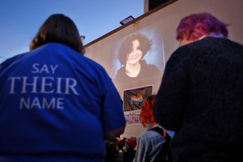 A photograph of Nex Benedict, a nonbinary teenager who died one day after a fight in a high school bathroom, is projected during a candlelight service at Point A Gallery in Oklahoma City on Feb. 24, 2024.