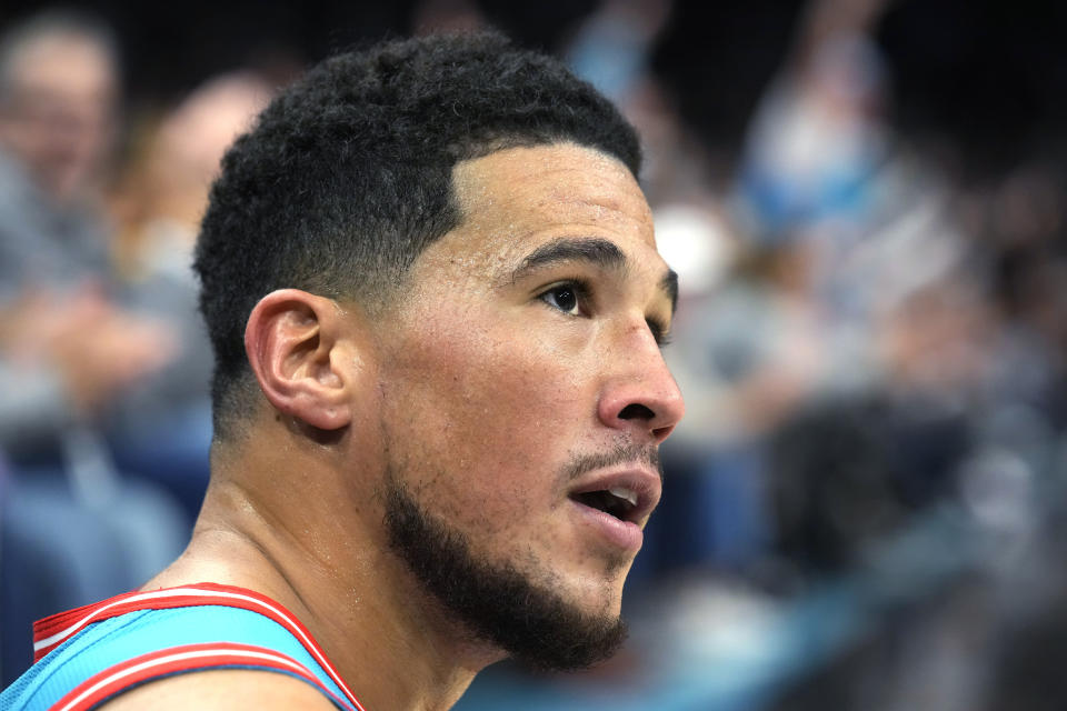 Phoenix Suns guard Devin Booker reacts after being fouled during the second half of the team's NBA basketball game against the Houston Rockets, Friday, Dec. 2, 2022, in Phoenix. The Rockets won 122-121. (AP Photo/Rick Scuteri)