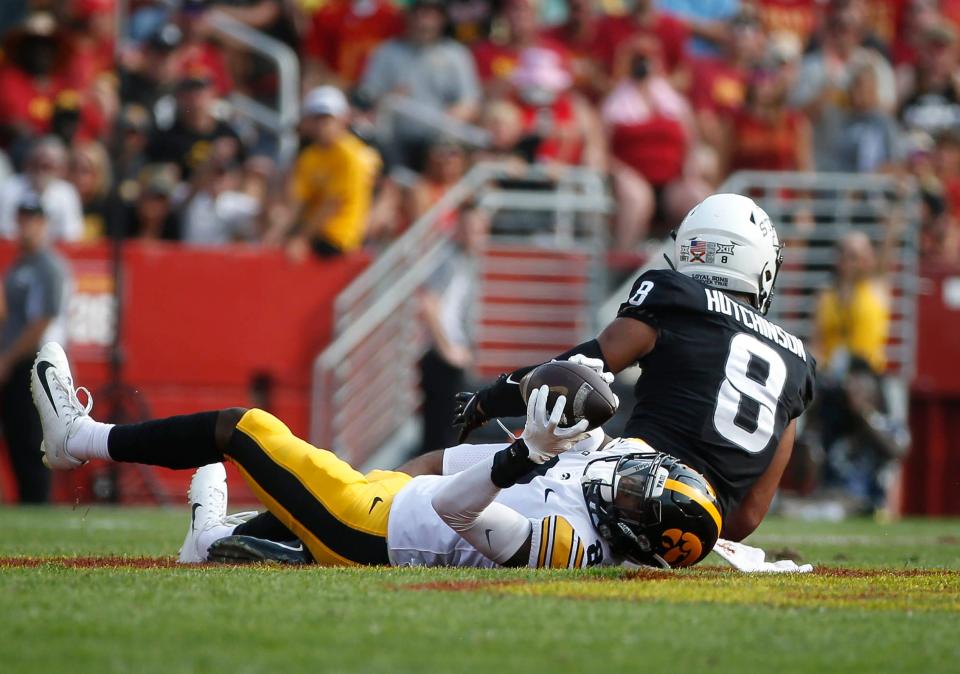 Iowa senior defensive back Matt Hankins concentrates on a live ball as he pulls down an interception over Iowa State receiver Xavier Hutchinson in the second quarter at Jack Trice Stadium in Ames on Saturday, Sept. 11, 2021.