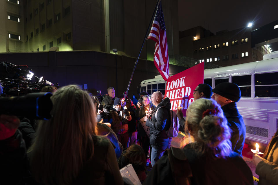 Matt Braynard, center, speaks during a candlelight vigil in support of the so-called "political prisoners" of the Jan. 6 insurrection at the U.S. Capitol, at the Washington's Central Detention Facility where several are being held, Thursday, Jan. 6, 2022, in Washington. (AP Photo/Alex Brandon)