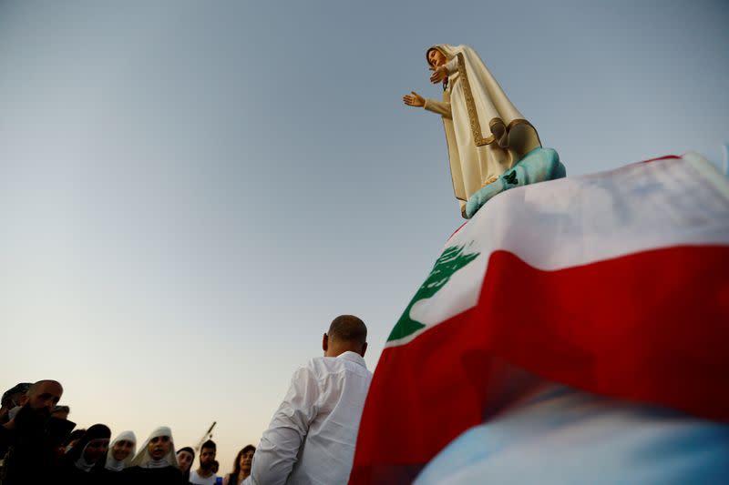 People attend a prayer near the site of a massive explosion in Beirut