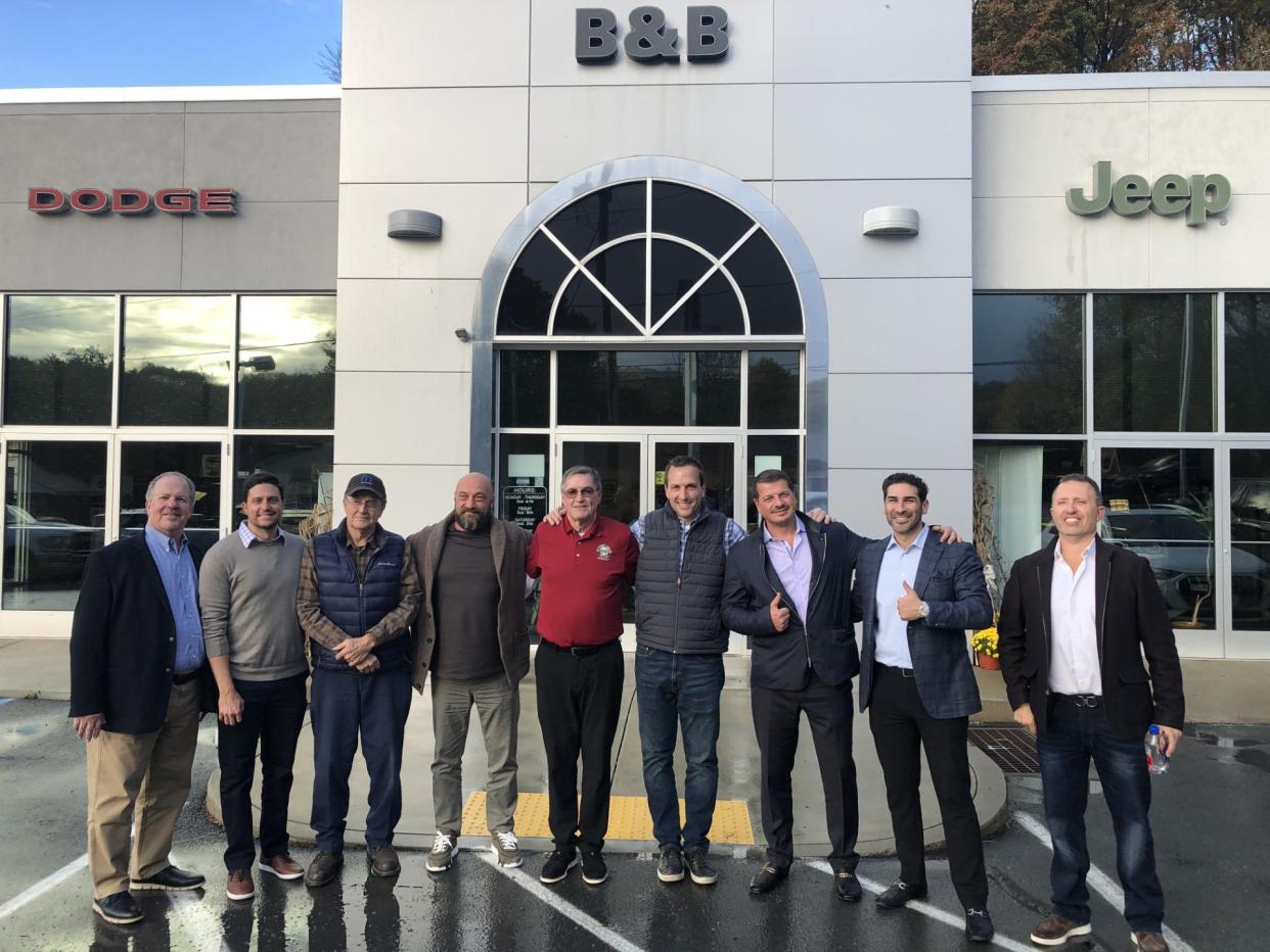 Honesdale Chrysler Dodge Jeep Ram (CDJR) is the new name under new ownership of the longtime B&B Chrysler Dodge Jeep Ram, better known locally as B&B Dodge, which had been owned by the Carmody family since 1970. The closing was held Oct. 16, 2023. From left are Gershon Rosenzweig and Matt Wilkins, Performance Brokerage Services; John Carmody, retiring as B&B service manager; new co-owner Yan Chertok, Honesdale CDJR; Steve Carmody Sr., retiring as sales manager, B&B; Steve Carmody Jr., business manager; new co-owner Artem Boguslavskiy, Honesdale CDJR; Seth Dobbs, attorney for buyer; Alex Sirota, partner with Dunhill Auto Group, Ltd.