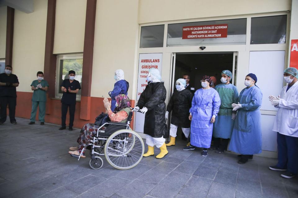 An 83-year-old Ayse Polat, who tested positive for coronavirus is discharged from hospital with applause after she recovered from in Antalya, Turkey on April 7.