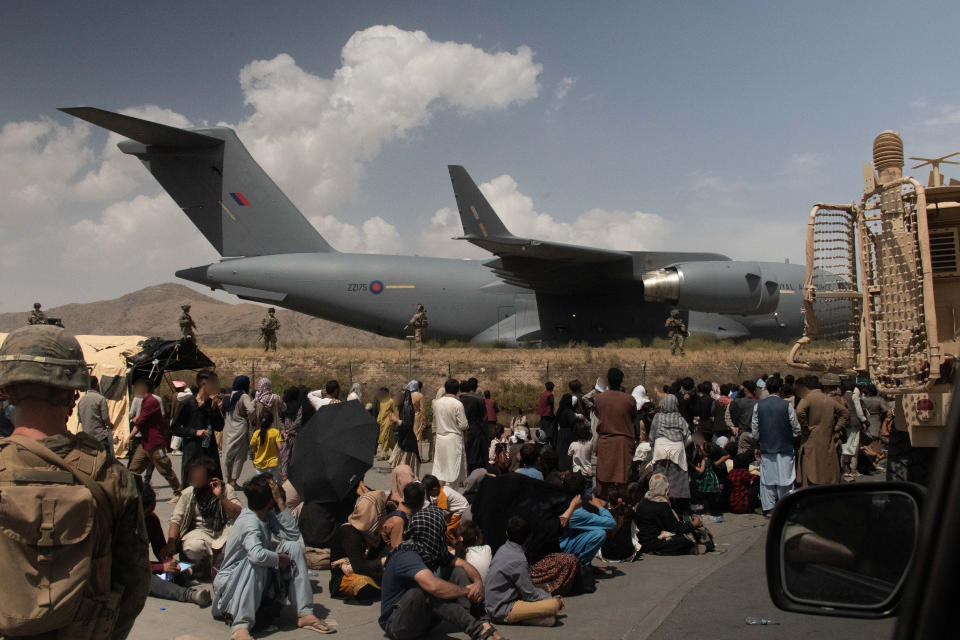 Evacuees wait in front of a Royal Air Force C-17 at Kabul airport (LPhot Ben Shread/MoD/PA)