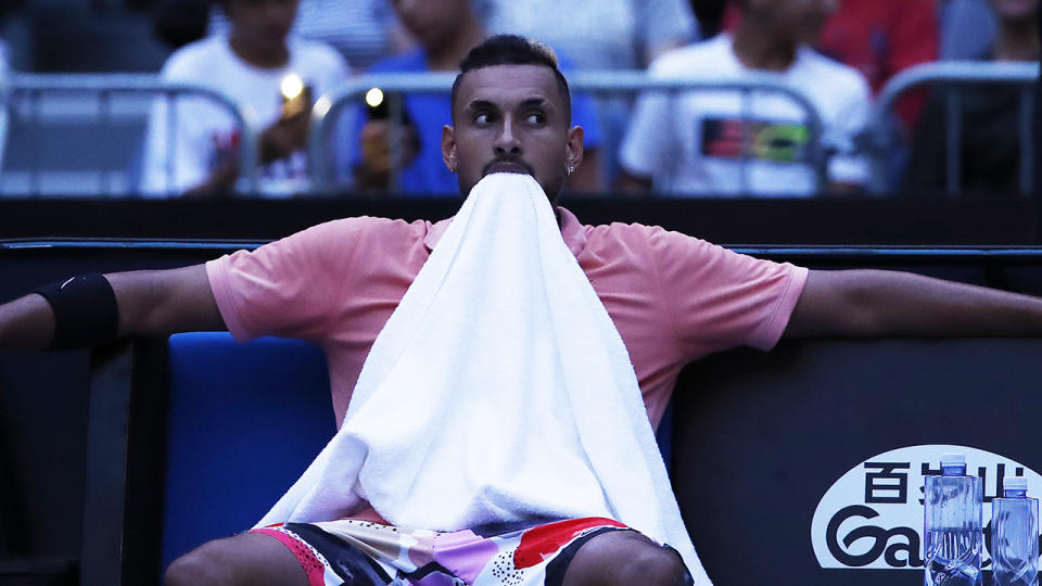 Nick Kyrgios pictured at Melbourne Park, sat back after the lights went out in the stadium.