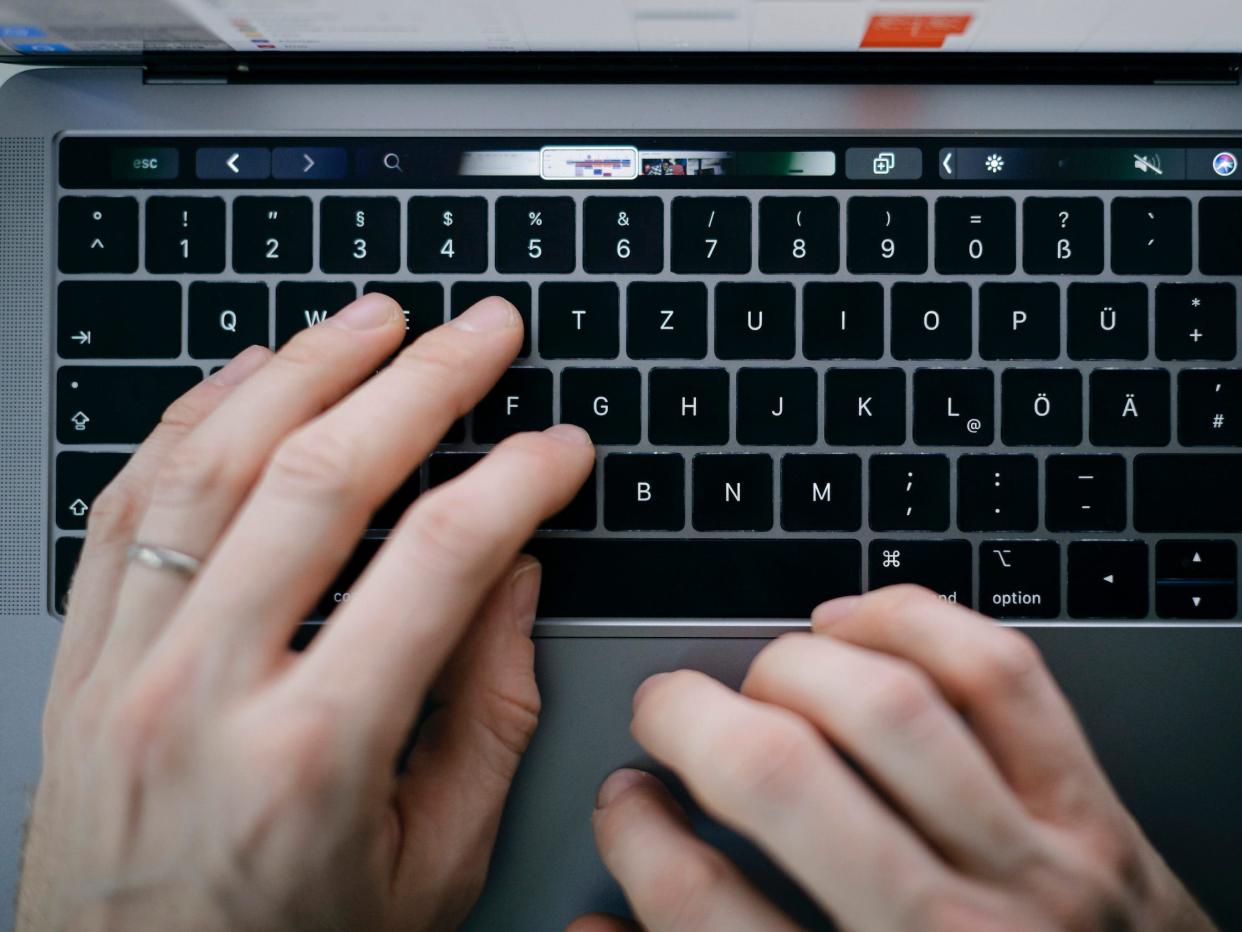 Symbol photo. A man is typing with his hands on a keyboard of a MacBook Pro on February 04, 2020 in Berlin, Germany.