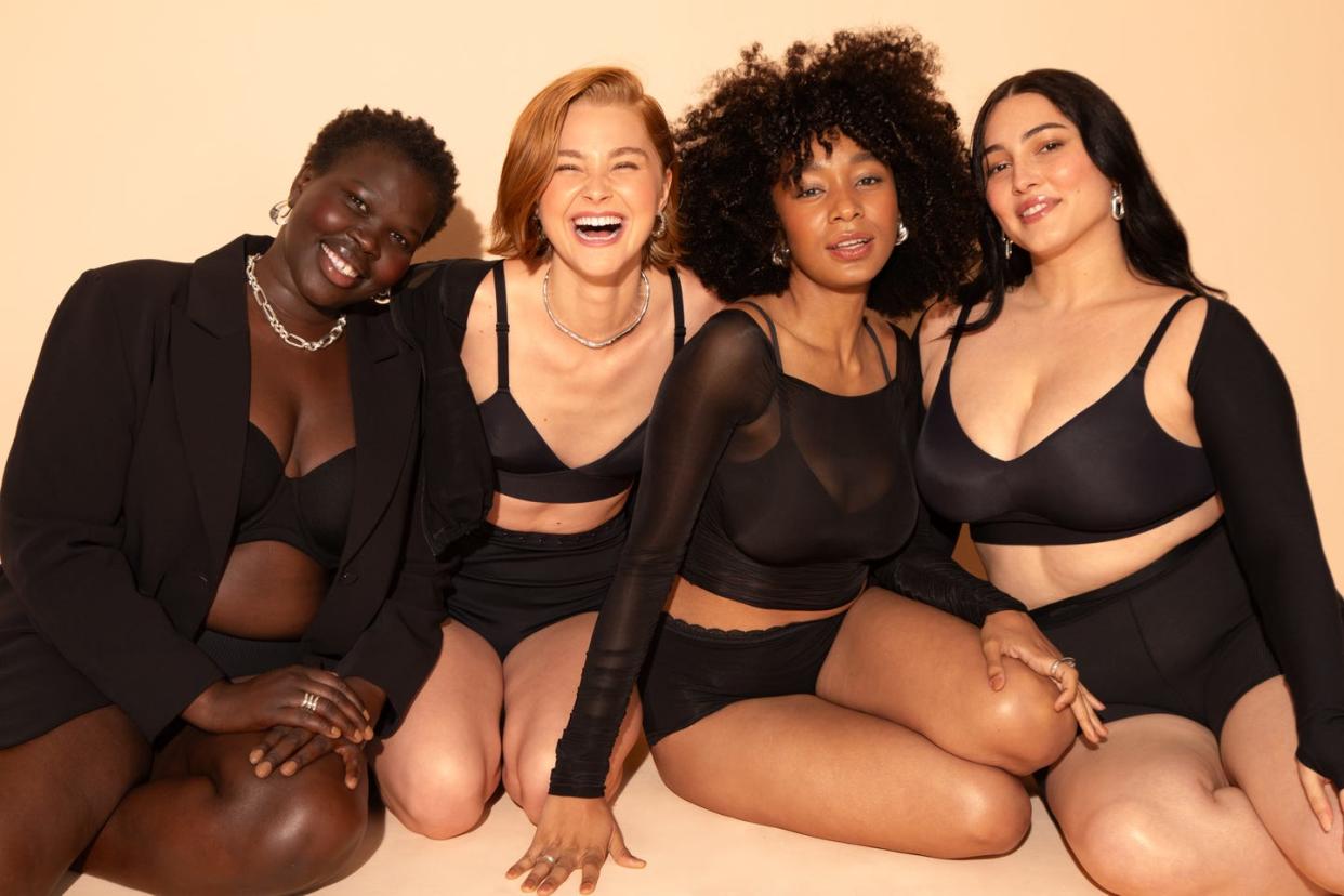 group of women wearing black bras