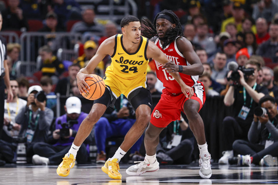 Mar 9, 2023; Chicago, IL, USA; Iowa Hawkeyes forward Kris Murray (24) is defended by Ohio State Buckeyes guard Isaac Likekele (13) during the first half at United Center. Mandatory Credit: Kamil Krzaczynski-USA TODAY Sports