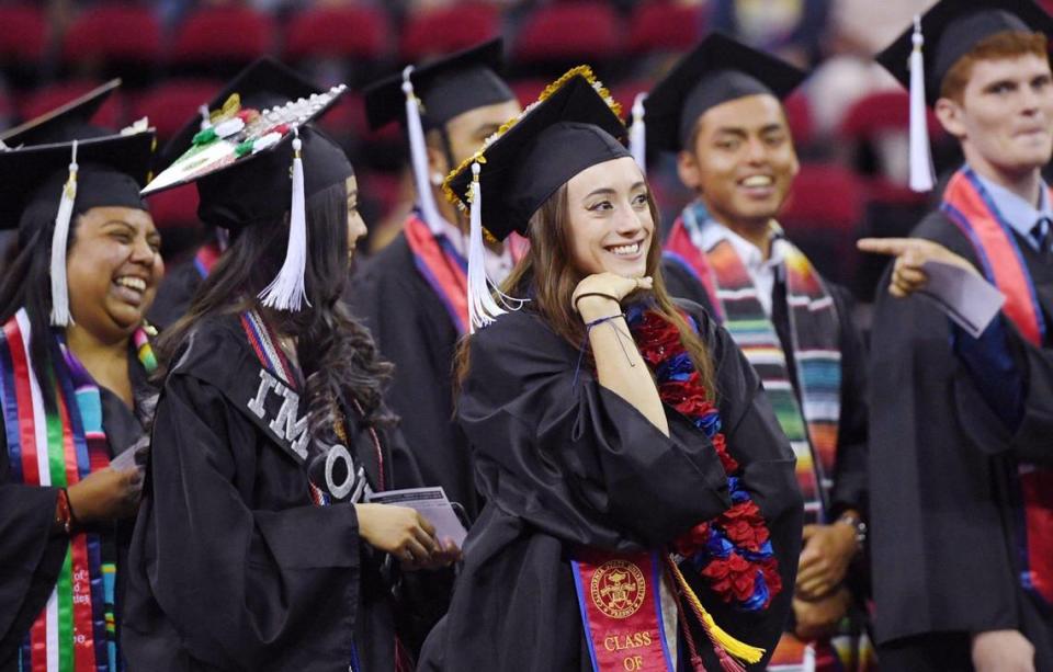 Siena Simas, center, poses as she and four hundred and fifty students gathered for Fresno State’s College of Arts and Humanities commencement exercise Friday, May 20, 2022 in Fresno.