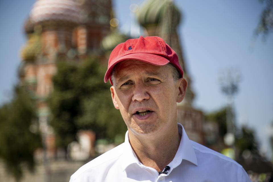Valery Tsepkalo, a former ambassador to the United States and founder of a successful hi-tech park, speaks during his interview with the Associated Press near Red Square in Moscow, Russia, Tuesday, July 28, 2020, with St. Basil's Cathedral and Spasskaya Tower in the background. Valery Tsepkalo who fled to Russia after being denied a ballot spot in next month’s presidential election says he my not be able to return home if authoritarian President Alexander Lukashenko wins another term. He fled to Russia last week and said he had received tips that his arrest was imminent. (AP Photo/Alexander Zemlianichenko)