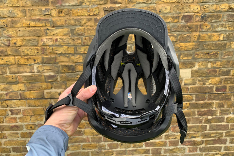 Male cyclist holding the Bollé Halo React MIPS helmet