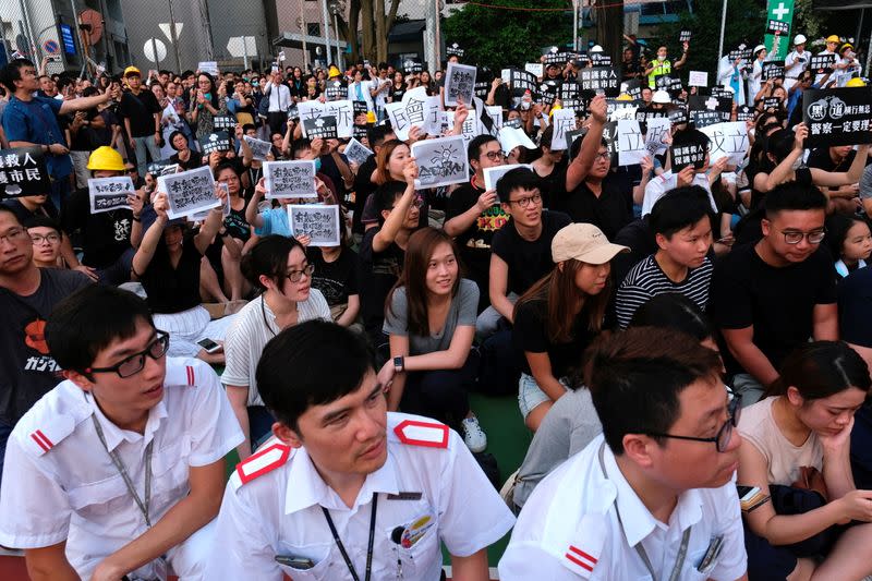 FILE PHOTO: Public hospital doctors, nurses and employees attend a rally against Sunday’s Yuen Long violent attacks over extradition bill protesters and citizens, at Queen Elizabeth Hospital, in Hong Kong