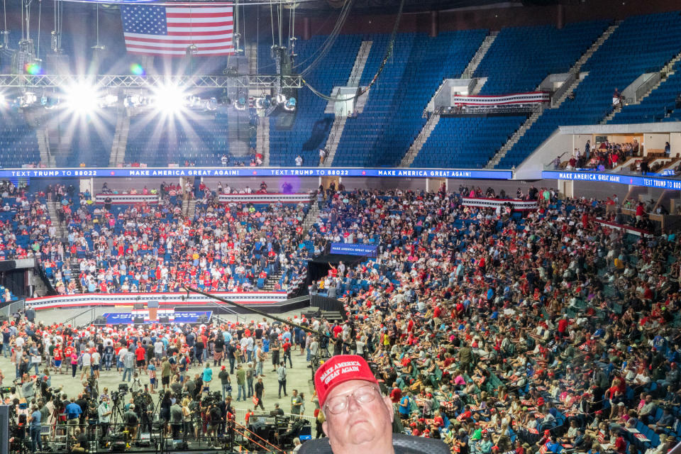 <strong>Tulsa, June 20, 2020.</strong> "I feel like this country is increasingly living in parallel worlds. The Trump rally today was bizarre. Indoors, everyone bunched together, barely anybody wearing a mask. I looked like an alien in my respirator and goggles. I was mocked a bit, and responded with my story of seeing trucks filled with bodies in New York at the height of the pandemic's first wave in America. I suppose this will be a super-spreader event. George Floyd was not mentioned even once. As people started to stream out during the 90-minute speech, I left to see if there would be confrontations with protesters. There were some scattered shouting matches and a bit of scuffling, but mostly the two groups left one another alone. One attendee of the rally carried a handmade cross, and a protester tried to snatch it out of his hand. He yanked it back, held it in the air and started chanting, 'Peace, peace, peace.' The crowd of protesters and Trump supporters around him took up the chant, filling the air. That night, my colleague Ruddy Roye and I sat down with some Trump supporters at our hotel and had drinks. It was a surprisingly thoughtful and nuanced conversation."<span class="copyright">Peter van Agtmael—Magnum Photos for TIME</span>